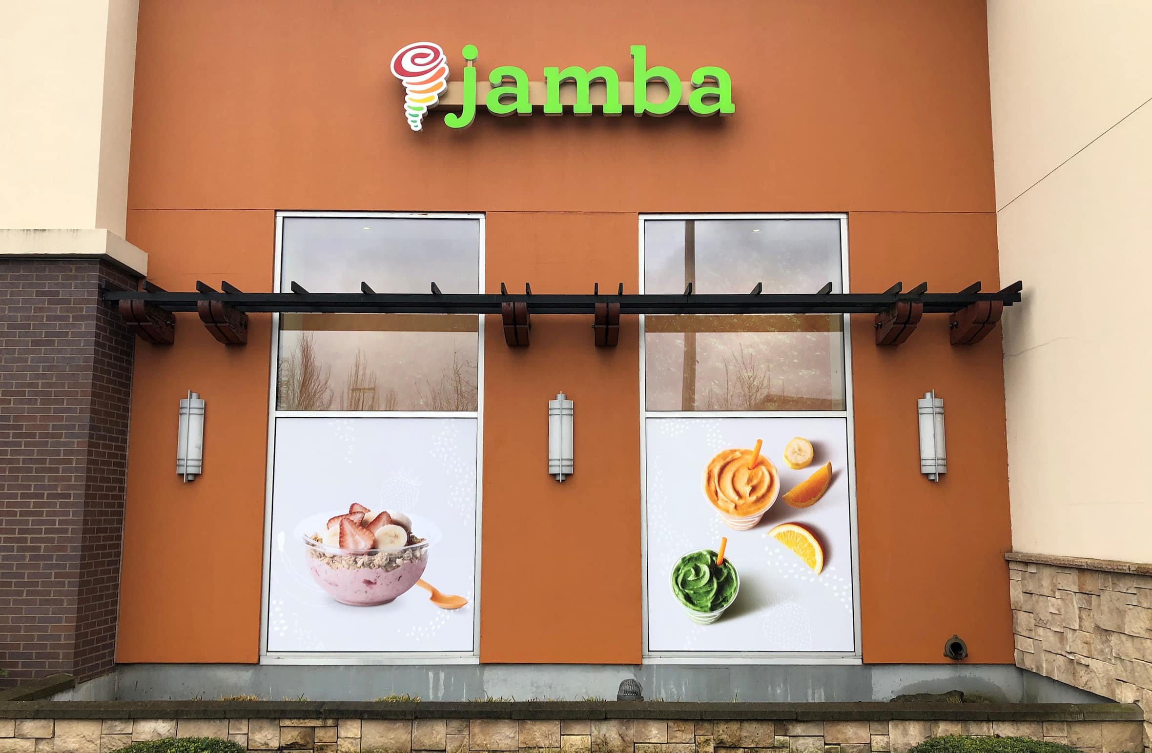Window graphics of fruit and smoothies on the side of a Jamba Juice storefront